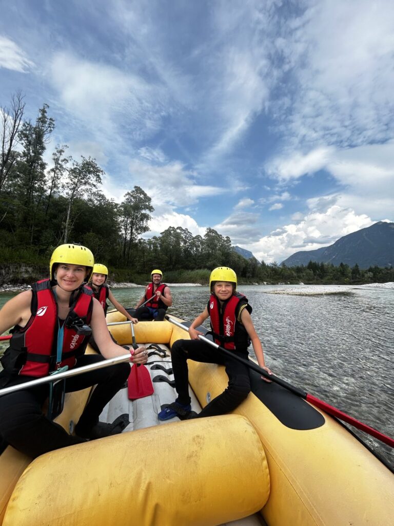 Young family of 4 having wonderful time on a raft on Soča river