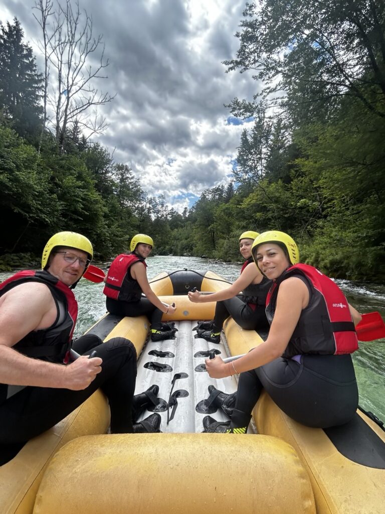 4 people on a raft having wonderful time.